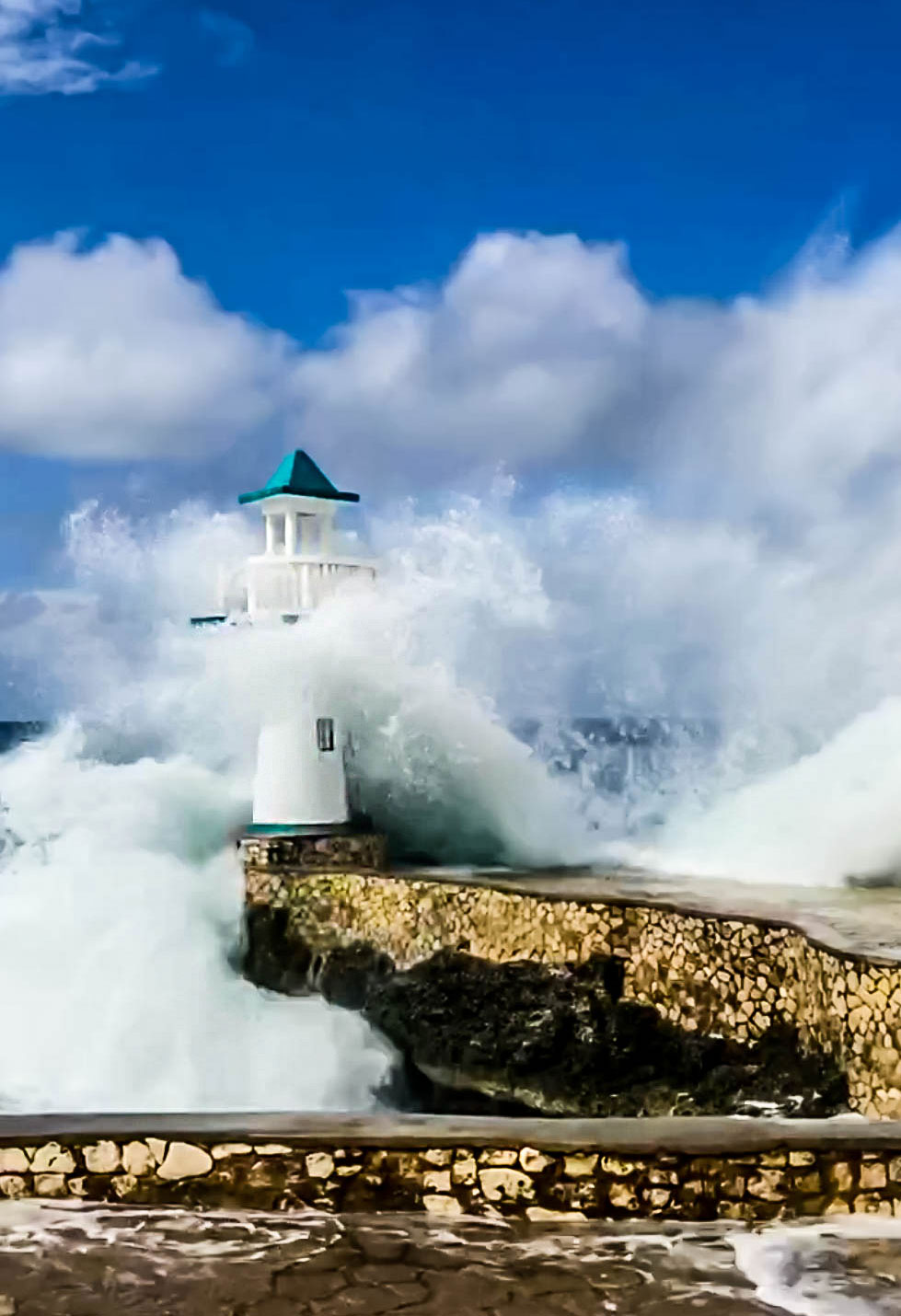 Big waves hitting lighthouse on cliffs in West End, Jamaica