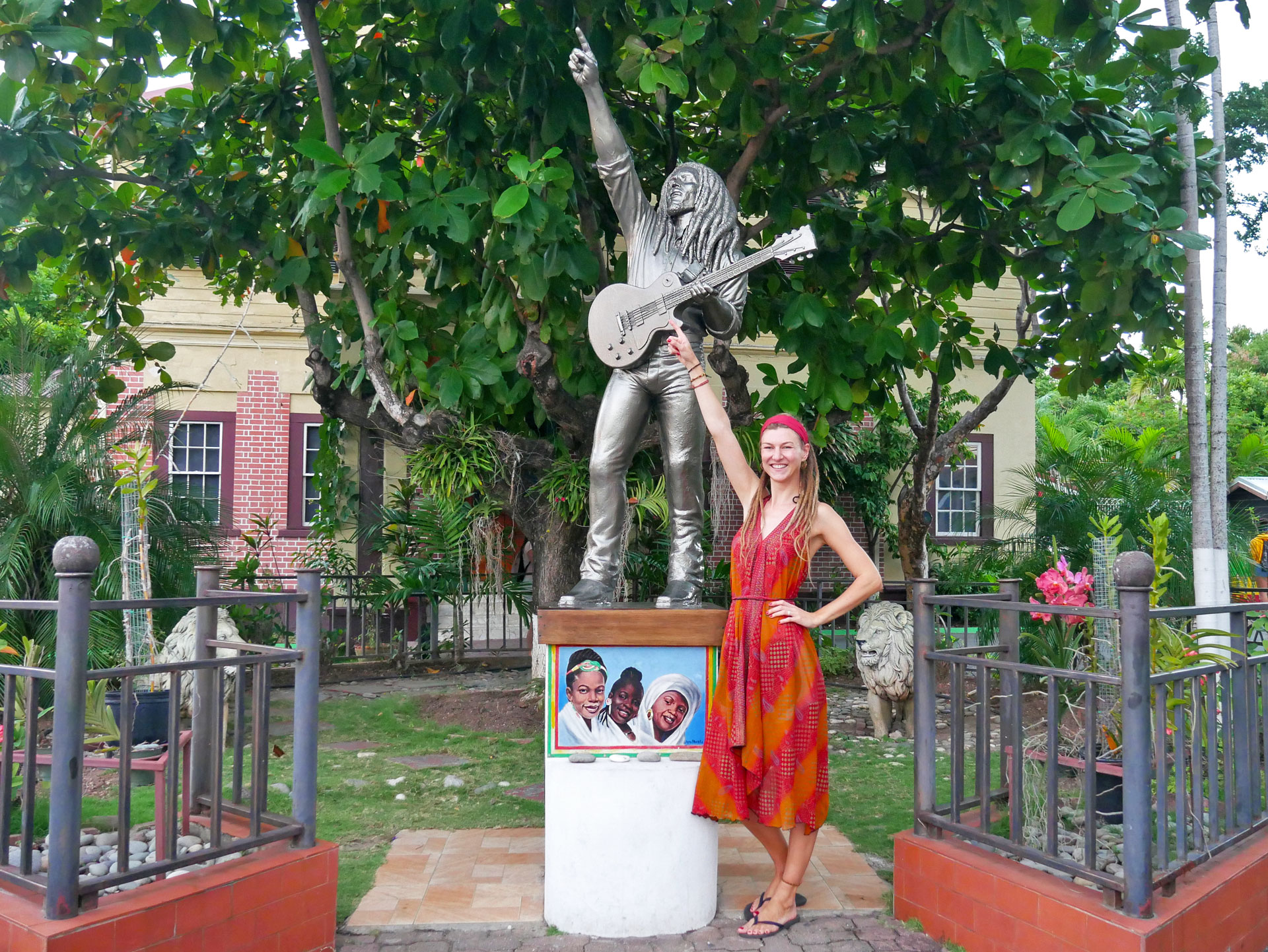 Rasta girl and Bob Marley statue at museum in Kingston, Jamaica