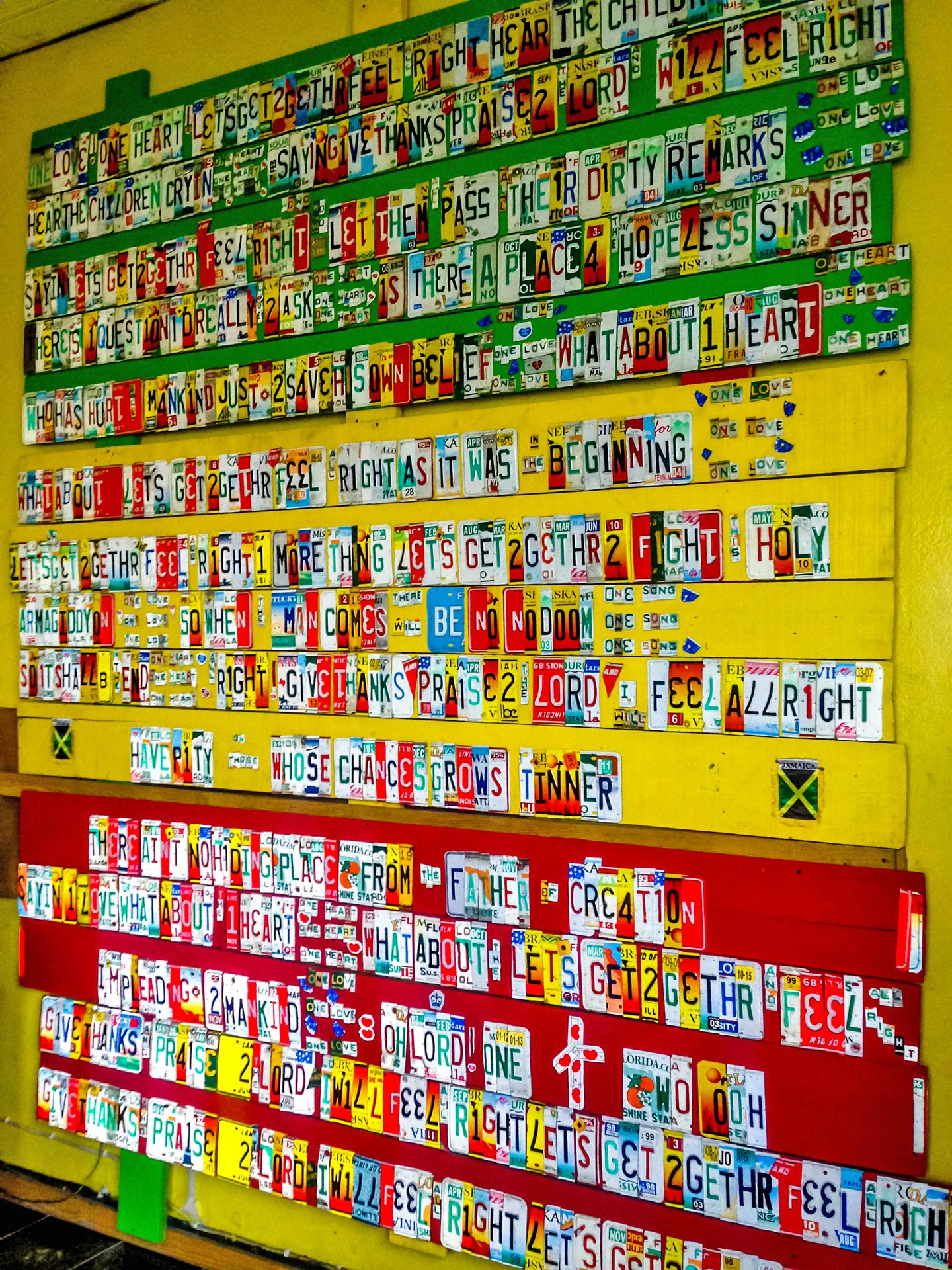 Lyrics of One Love made out of license plates at Tuff Gong International, Kingston