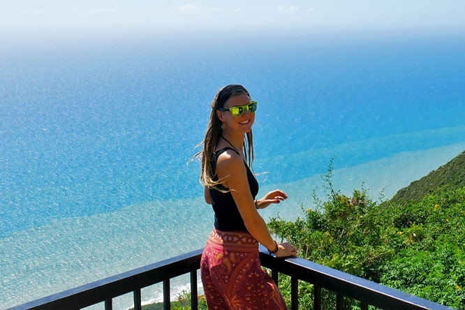 Rasta girl at Lovers Leap overlooking ocean in Southfield, Jamaica