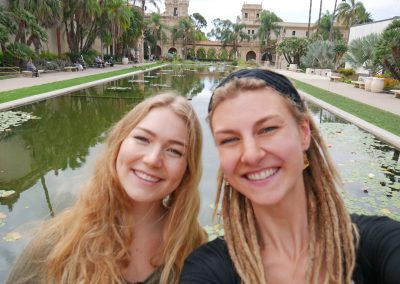 Sisters at Balboa Park with Lily Pond and Casa de Balboa in the background