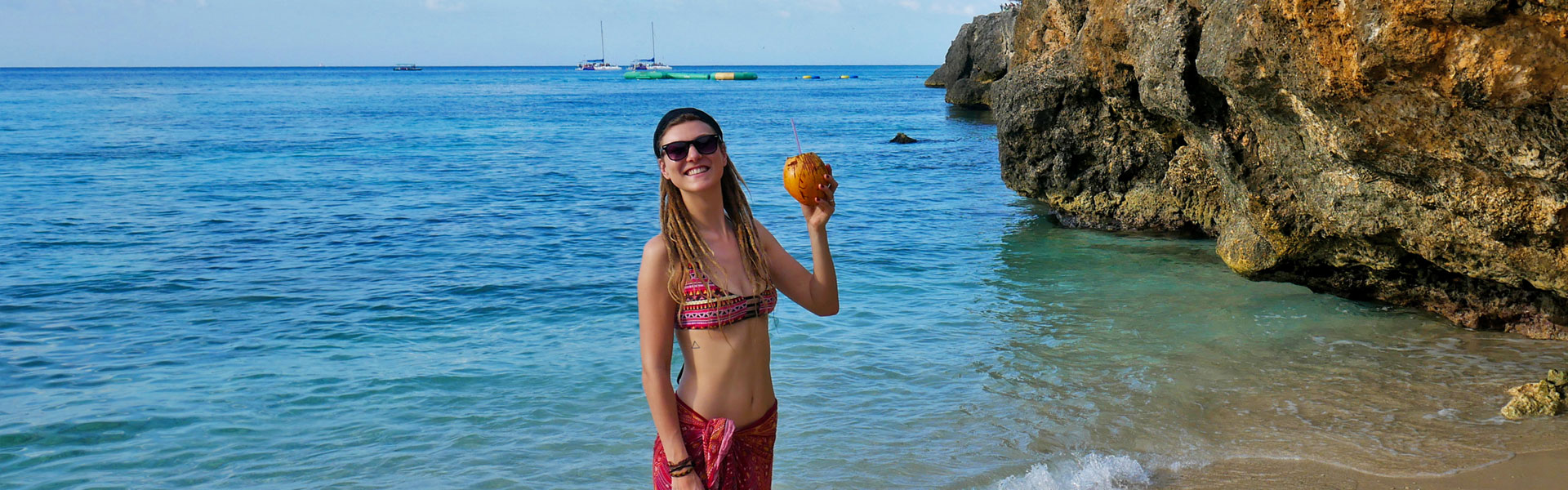 Rasta girl with coconut at beach in Montego Bay, Jamaica