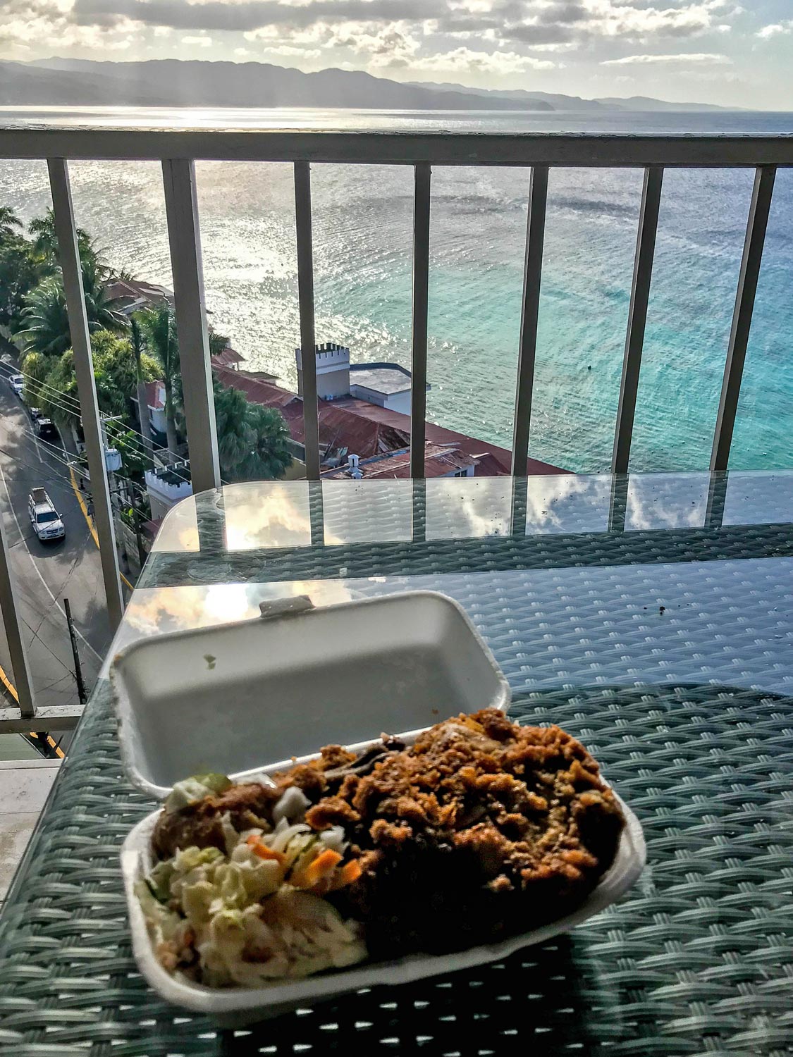 Chicken lunch on balcony overlooking ocean and hip strip in Montego Bay, Jamaica