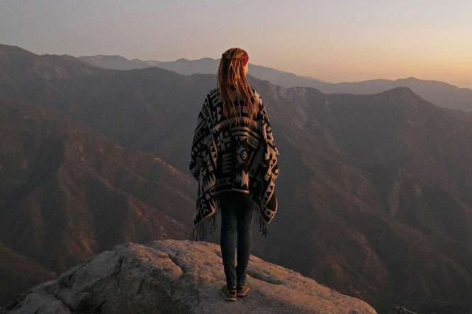 Rasta girl watching sunset from Moro Rock in Sequoia National Park