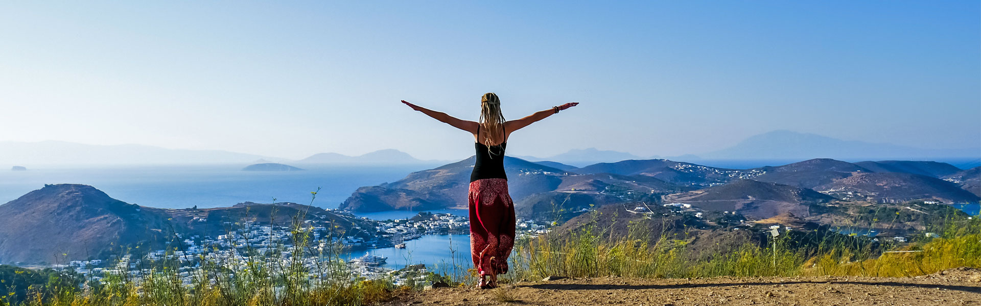 Dreadlock girl on Patmos overlooking ocean and islands