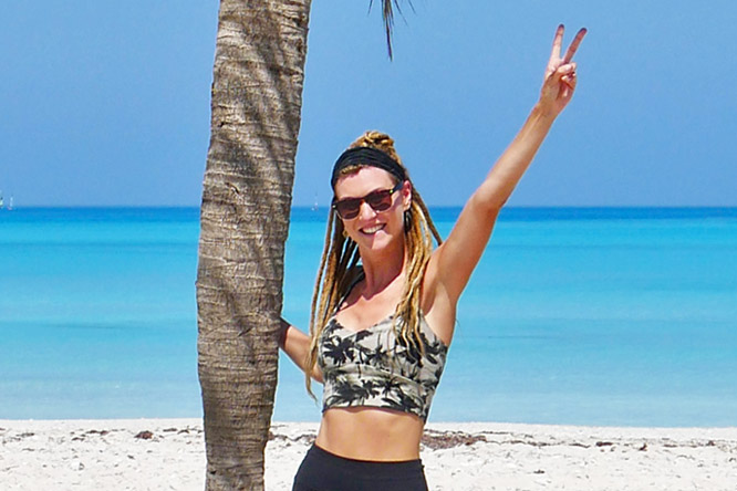 Dreadlock girl showing peace sign at Varadero beach in Cuba