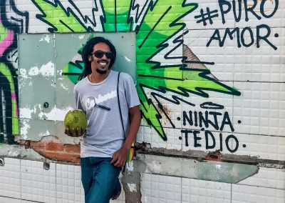 Rastaman in front of cannabis graffiti in Peruíbe, Brazil
