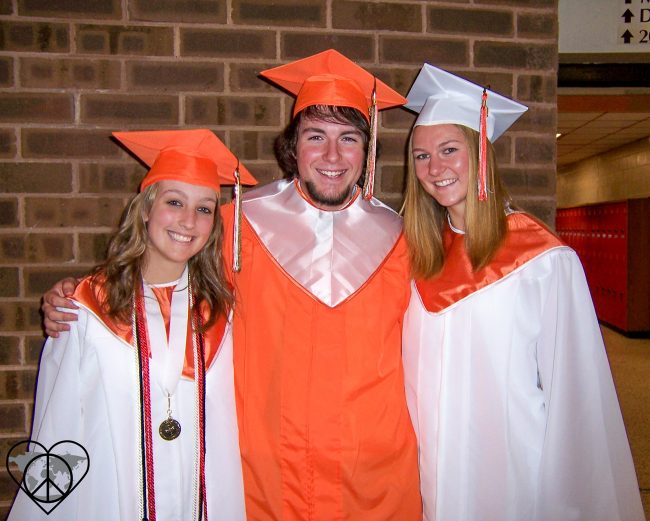 Three High School students in their graduation gowns
